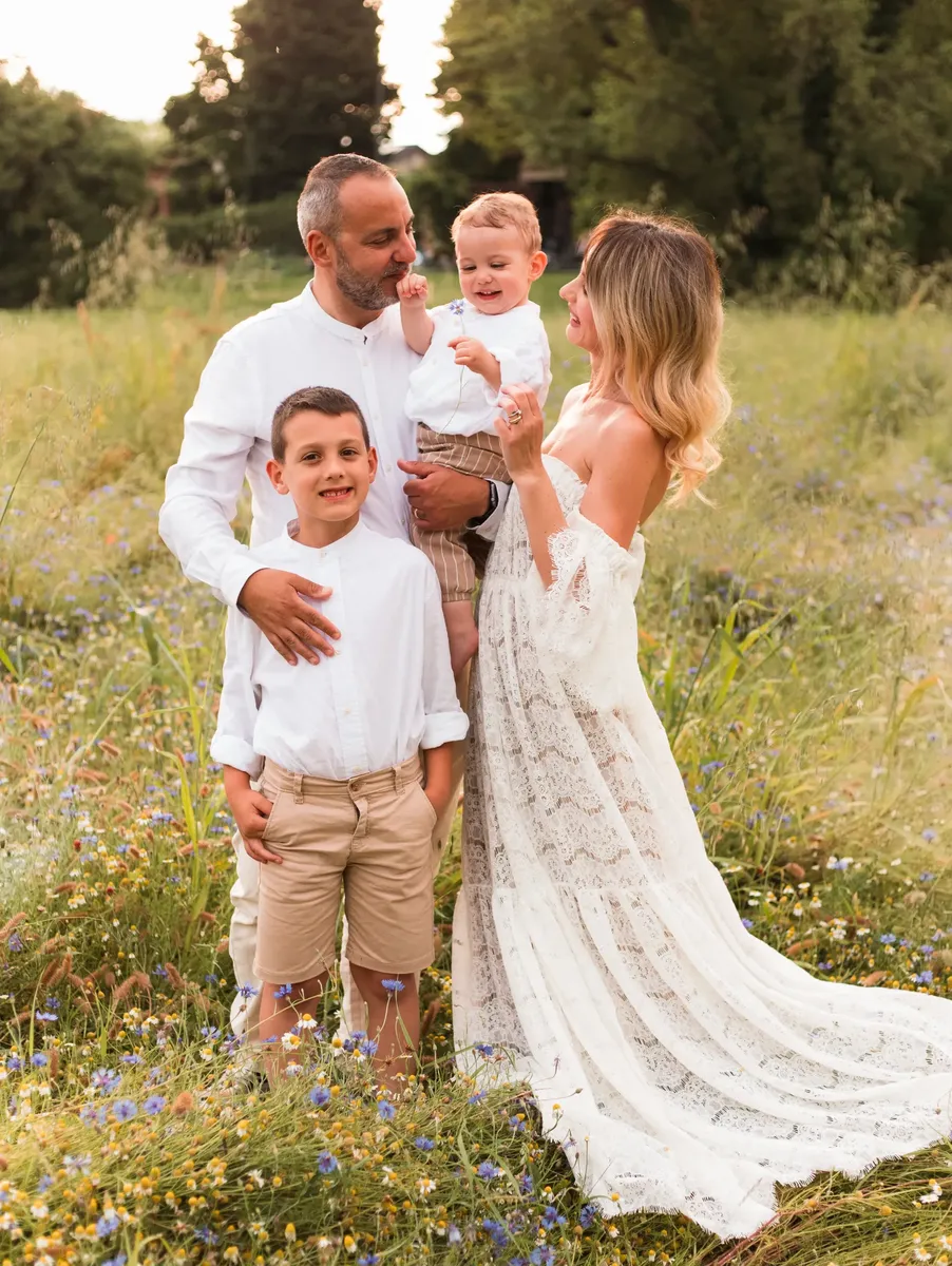 Famiglia di quattro persone tra fiori di campo al tramonto, fotografia famiglia Milano